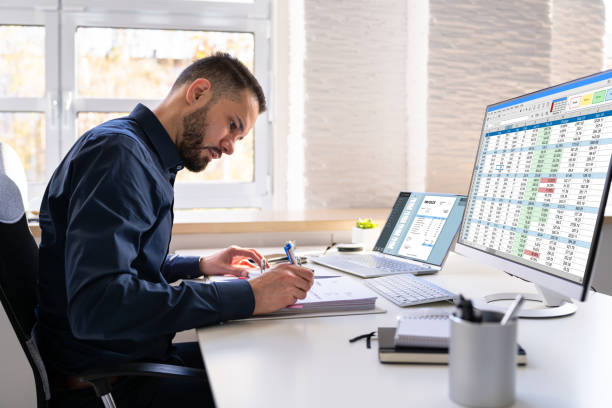 Analyst Working With Spreadsheet On Computer Screen Person crunching data or balancing books